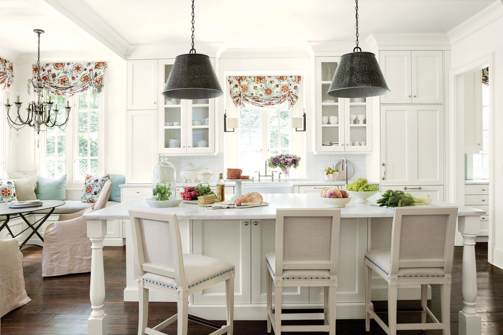 Inspiration for a timeless eat-in kitchen remodel in Atlanta with a farmhouse sink, recessed-panel cabinets, white backsplash, subway tile backsplash, marble countertops and white cabinets