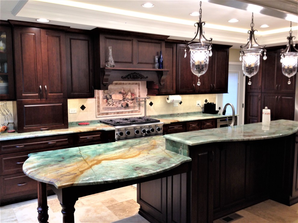 Eat-in kitchen - mid-sized transitional travertine floor and beige floor eat-in kitchen idea in Chicago with a double-bowl sink, raised-panel cabinets, dark wood cabinets, quartzite countertops, beige backsplash, stone tile backsplash, stainless steel appliances and an island