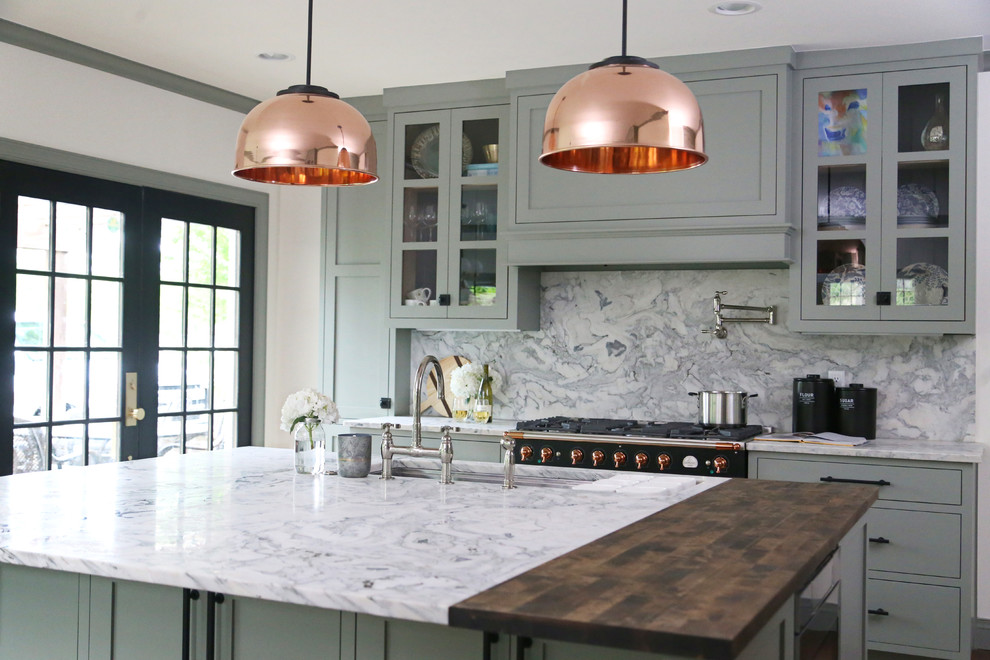 Example of a small transitional l-shaped medium tone wood floor and brown floor eat-in kitchen design in Other with an undermount sink, shaker cabinets, green cabinets, marble countertops, gray backsplash, marble backsplash, stainless steel appliances, an island and gray countertops