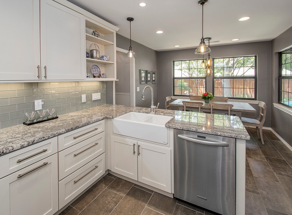 Mid-sized elegant galley porcelain tile eat-in kitchen photo in Dallas with a farmhouse sink, shaker cabinets, white cabinets, granite countertops, gray backsplash, glass tile backsplash, stainless steel appliances and no island