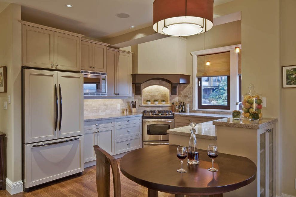 Example of a classic u-shaped kitchen design in Vancouver with recessed-panel cabinets, beige cabinets, beige backsplash, subway tile backsplash and paneled appliances