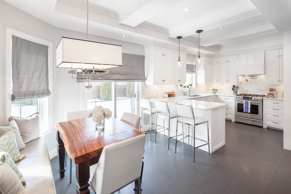 Example of a transitional l-shaped eat-in kitchen design in Toronto with a double-bowl sink, recessed-panel cabinets, white cabinets, white backsplash, stainless steel appliances and a peninsula