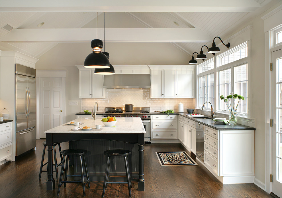 Example of a large transitional u-shaped dark wood floor and brown floor eat-in kitchen design in New York with a single-bowl sink, recessed-panel cabinets, white cabinets, marble countertops, white backsplash, subway tile backsplash, stainless steel appliances and an island