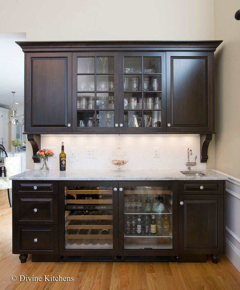 Example of a large classic galley light wood floor home bar design in Boston with beaded inset cabinets, yellow cabinets, granite countertops and white backsplash