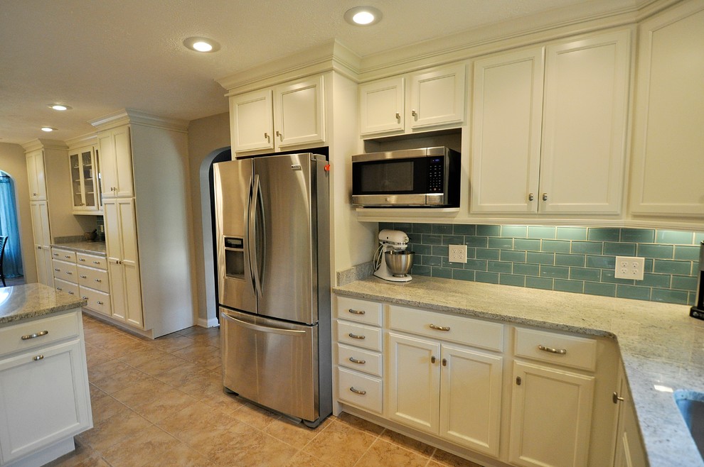 Inspiration for a traditional u-shaped kitchen/diner in Nashville with a submerged sink, recessed-panel cabinets, white cabinets, granite worktops, blue splashback, metro tiled splashback, stainless steel appliances, ceramic flooring and a breakfast bar.