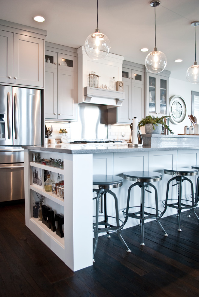 Inspiration for a large transitional l-shaped open concept kitchen remodel in Other with an undermount sink, flat-panel cabinets, gray cabinets, quartzite countertops, white backsplash, subway tile backsplash, stainless steel appliances and an island
