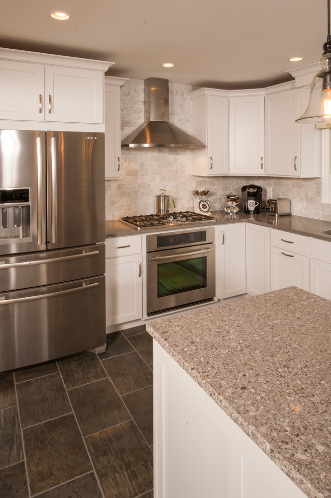 Eat-in kitchen - mid-sized transitional l-shaped porcelain tile eat-in kitchen idea in Philadelphia with an undermount sink, shaker cabinets, white cabinets, quartz countertops, white backsplash, stone tile backsplash, stainless steel appliances and an island