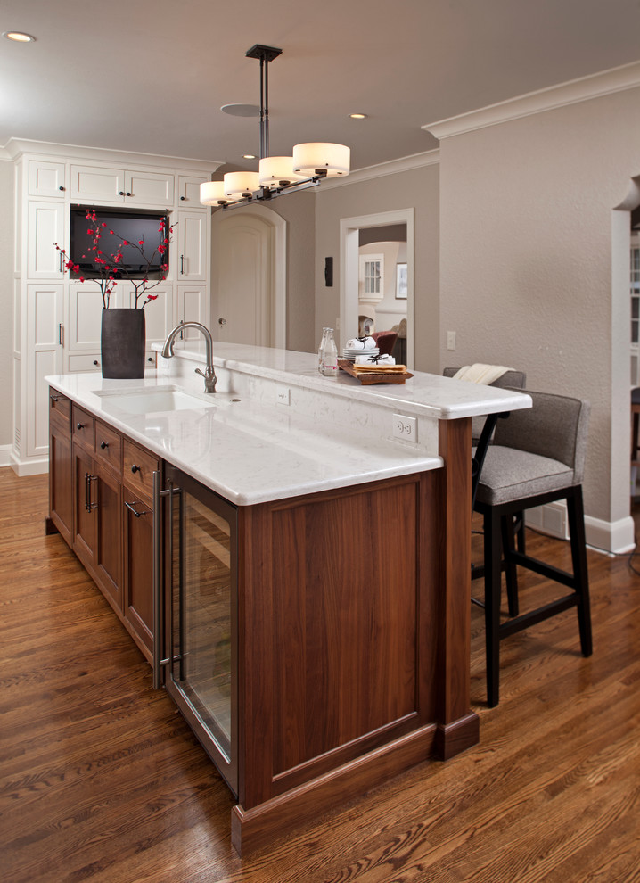 Inspiration for a mid-sized transitional galley dark wood floor kitchen remodel in Minneapolis with dark wood cabinets, an undermount sink, beaded inset cabinets, quartz countertops and an island