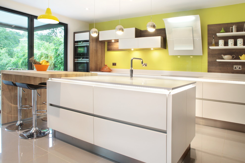 Inspiration for a mid-sized contemporary l-shaped porcelain tile open concept kitchen remodel in Buckinghamshire with glass sheet backsplash, stainless steel appliances, an island, yellow backsplash, an undermount sink, flat-panel cabinets, white cabinets and quartzite countertops