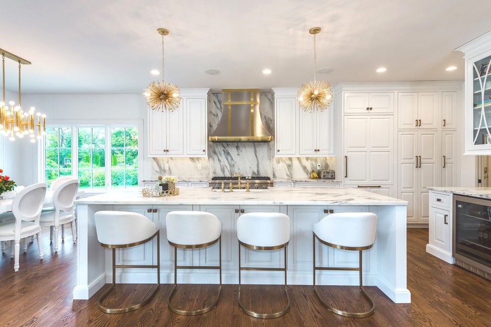 Transitional medium tone wood floor eat-in kitchen photo in St Louis with a farmhouse sink, beaded inset cabinets, white cabinets, marble countertops, white backsplash, stone slab backsplash, stainless steel appliances and an island