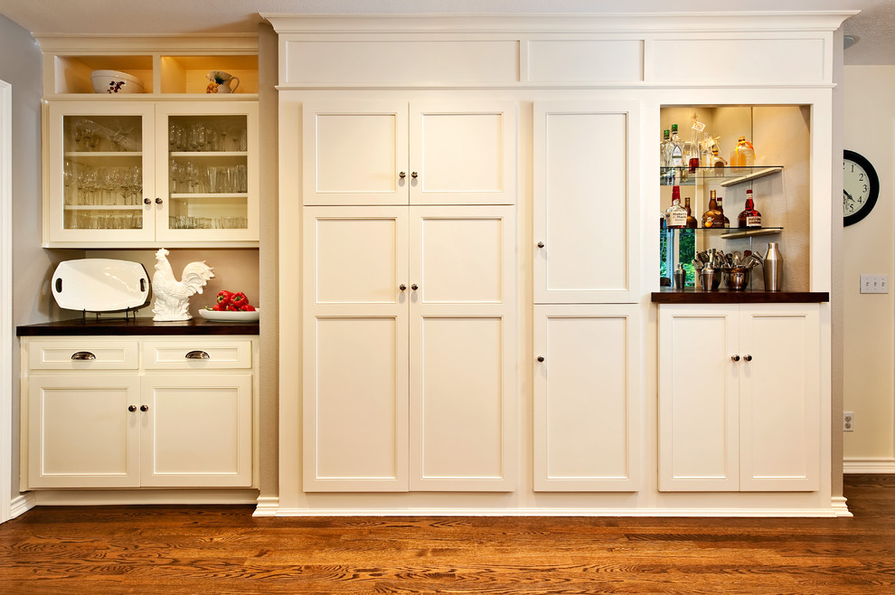 Mid-sized elegant medium tone wood floor kitchen pantry photo in Portland with recessed-panel cabinets and white cabinets