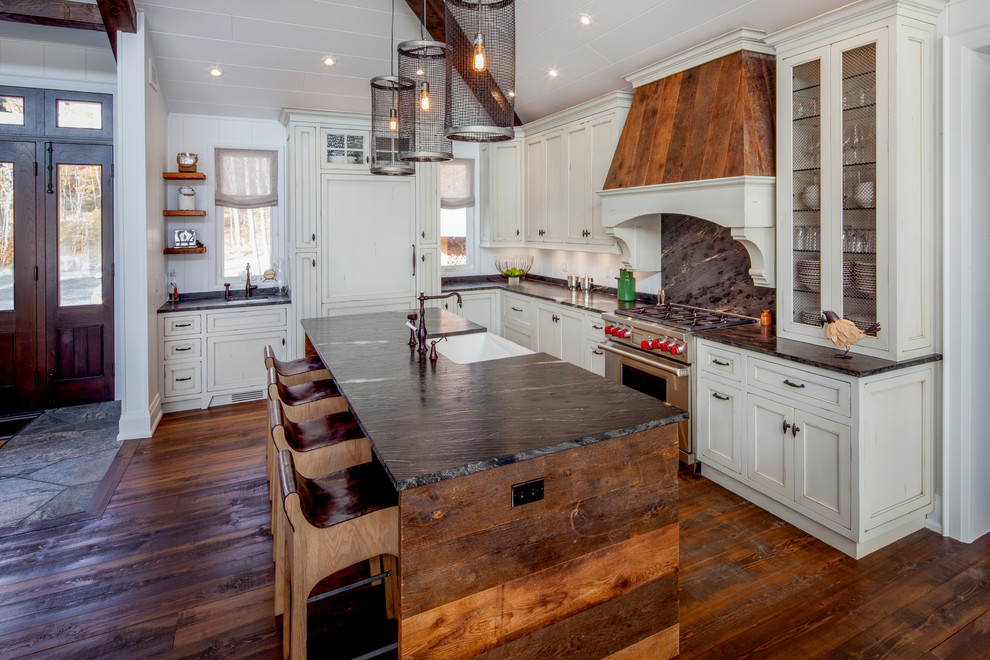 Exempel på ett stort lantligt kök, med en rustik diskho, skåp i shakerstil, vita skåp, granitbänkskiva, vitt stänkskydd, integrerade vitvaror, mörkt trägolv, en köksö och brunt golv