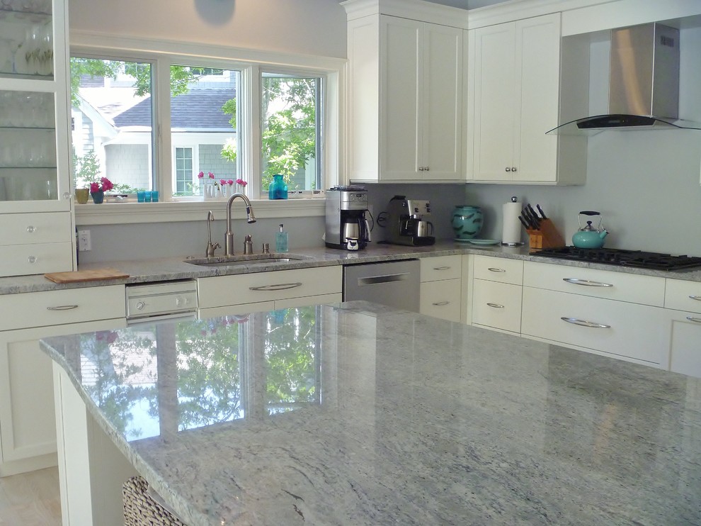 Example of a mid-sized transitional l-shaped light wood floor eat-in kitchen design in Boston with a double-bowl sink, flat-panel cabinets, white cabinets, granite countertops, stainless steel appliances and an island