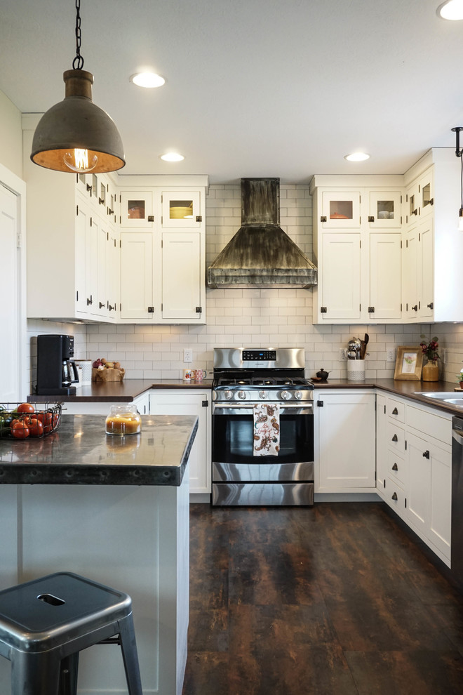 Inspiration for a small country u-shaped dark wood floor and brown floor kitchen pantry remodel in Columbus with a drop-in sink, white cabinets, zinc countertops, white backsplash, subway tile backsplash, stainless steel appliances, an island and shaker cabinets