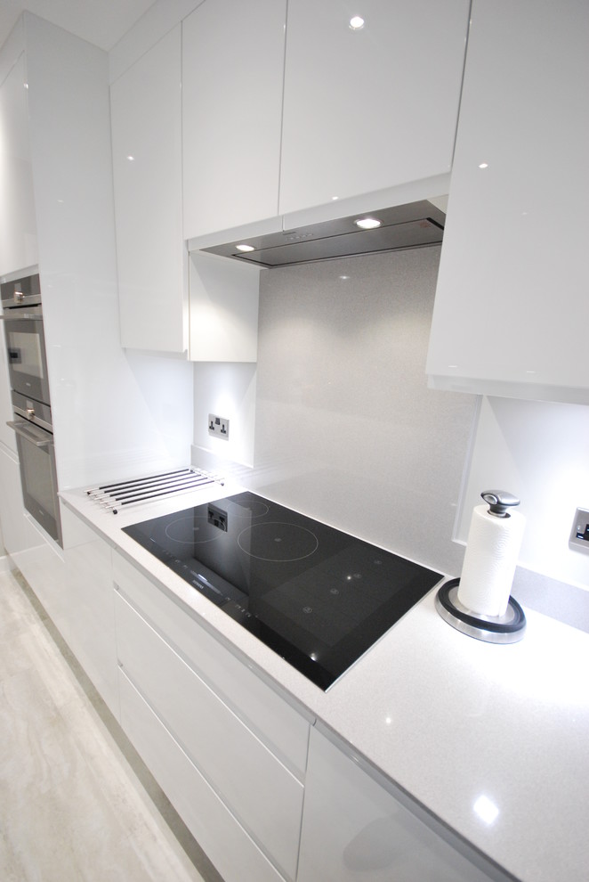 White gloss jpull contemporary kitchen with light grey quartz worktop