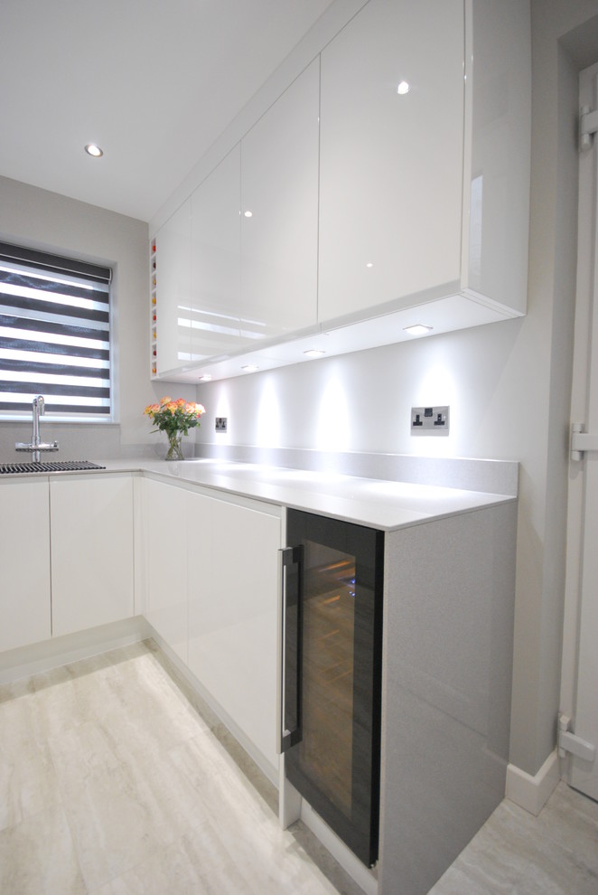 White gloss jpull contemporary kitchen with light grey quartz worktop