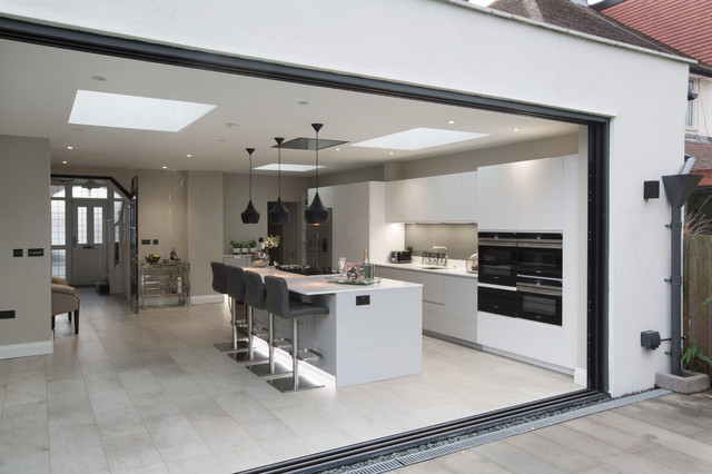 Modern white kitchen with breakfast bar and gothic style window