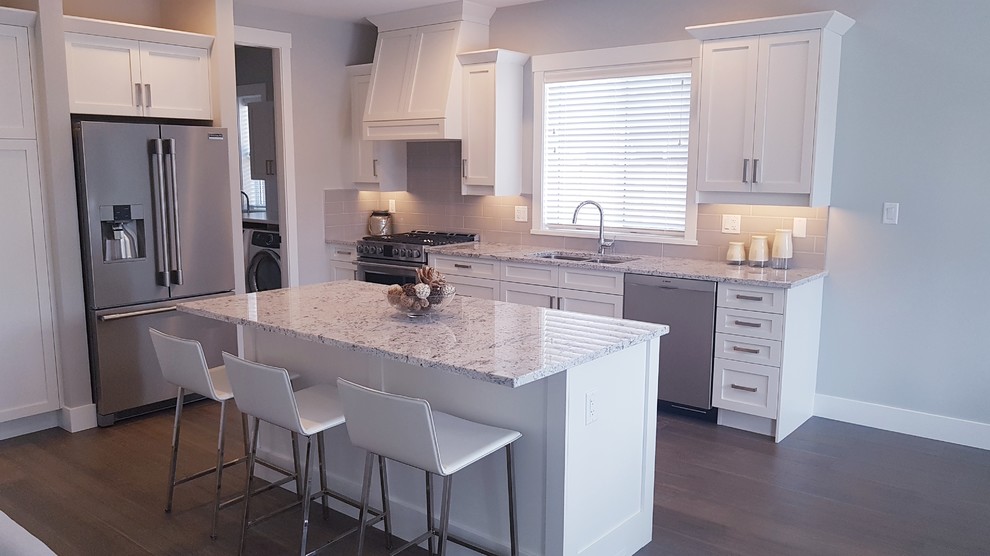 Eat-in kitchen - transitional eat-in kitchen idea in Vancouver with shaker cabinets, white cabinets, granite countertops, gray backsplash, subway tile backsplash, an island and white countertops