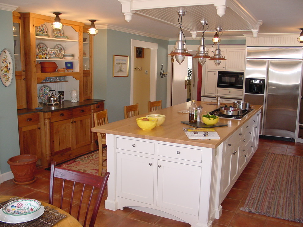 Design ideas for a traditional kitchen/diner in Portland Maine with shaker cabinets, white cabinets, wood worktops and stainless steel appliances.