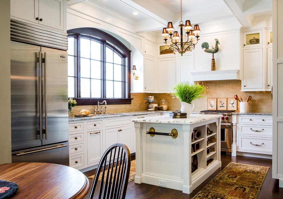 Example of a small classic l-shaped dark wood floor eat-in kitchen design in St Louis with shaker cabinets, white cabinets, beige backsplash, stainless steel appliances, an island, an undermount sink, quartz countertops and subway tile backsplash