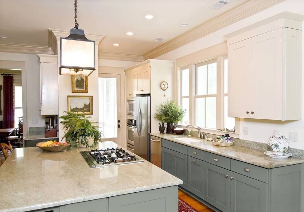 Elegant galley kitchen photo in Minneapolis with shaker cabinets, blue cabinets, stainless steel appliances, an undermount sink and white countertops