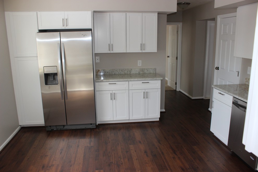 This is an example of a medium sized modern l-shaped enclosed kitchen in Philadelphia with shaker cabinets, white cabinets, granite worktops, grey splashback, stainless steel appliances, dark hardwood flooring and no island.