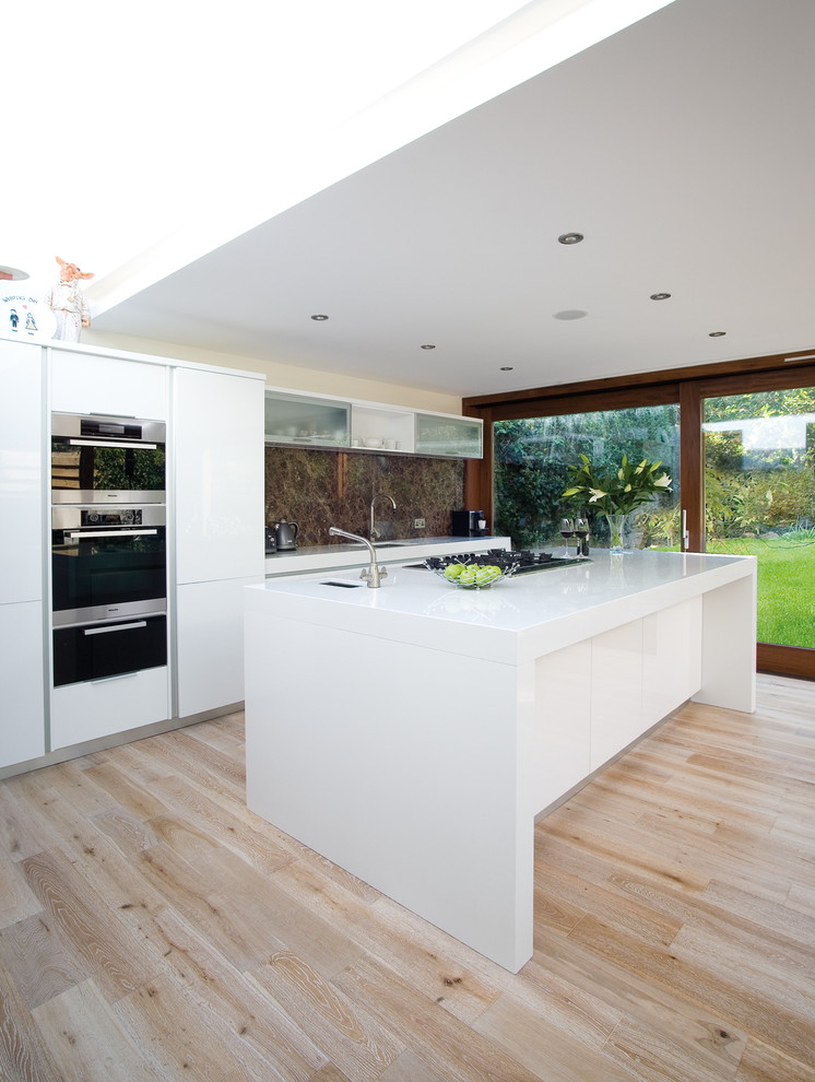 Trendy kitchen photo in Other with flat-panel cabinets, white cabinets, brown backsplash and stone slab backsplash
