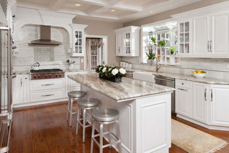 Eat-in kitchen - mid-sized transitional galley medium tone wood floor eat-in kitchen idea in Other with a farmhouse sink, granite countertops, stainless steel appliances and an island