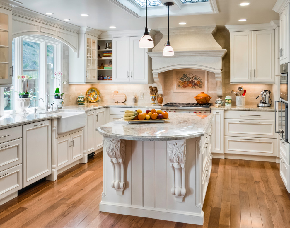 Design ideas for a traditional u-shaped kitchen/diner in San Francisco with a belfast sink, recessed-panel cabinets, white cabinets, beige splashback, porcelain splashback and stainless steel appliances.