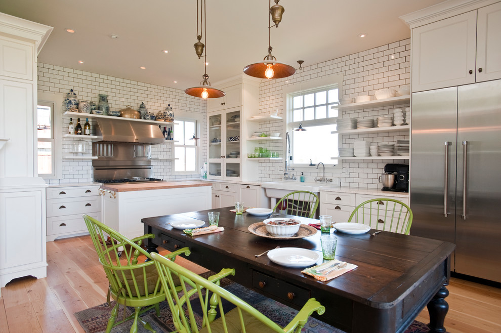 Eat-in kitchen - farmhouse u-shaped eat-in kitchen idea in Other with white cabinets, white backsplash, subway tile backsplash, stainless steel appliances, a single-bowl sink, shaker cabinets and marble countertops