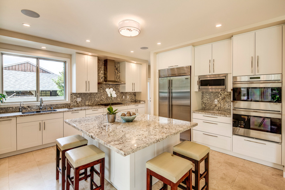 Enclosed kitchen - mid-sized contemporary l-shaped limestone floor and beige floor enclosed kitchen idea in Hawaii with a double-bowl sink, shaker cabinets, white cabinets, granite countertops, gray backsplash, stone slab backsplash, stainless steel appliances and an island