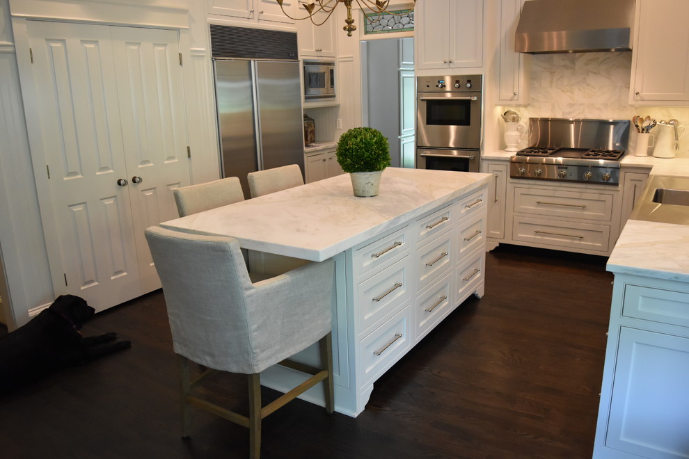 Immagine di una cucina classica di medie dimensioni con top in marmo, paraspruzzi bianco, elettrodomestici in acciaio inossidabile e parquet scuro
