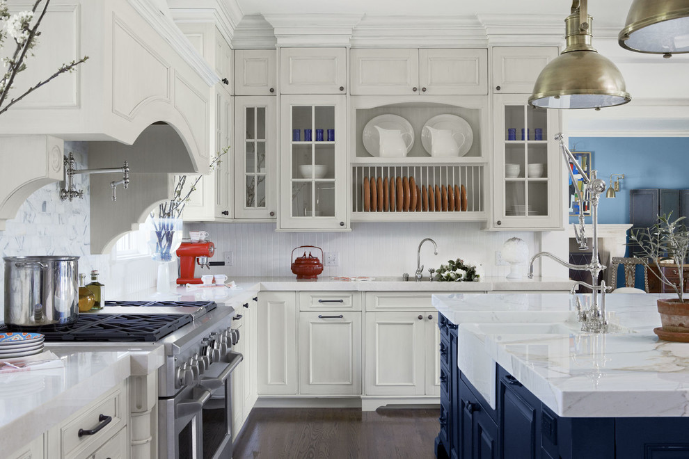 Inspiration for a classic l-shaped kitchen in Los Angeles with white cabinets, an island, a belfast sink, recessed-panel cabinets, stainless steel appliances, dark hardwood flooring, brown floors and white worktops.