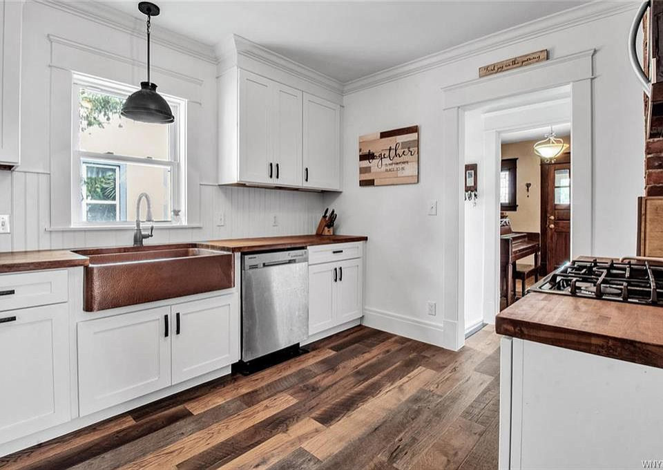 Photo of a small farmhouse u-shaped enclosed kitchen in Other with shaker cabinets, white cabinets and no island.