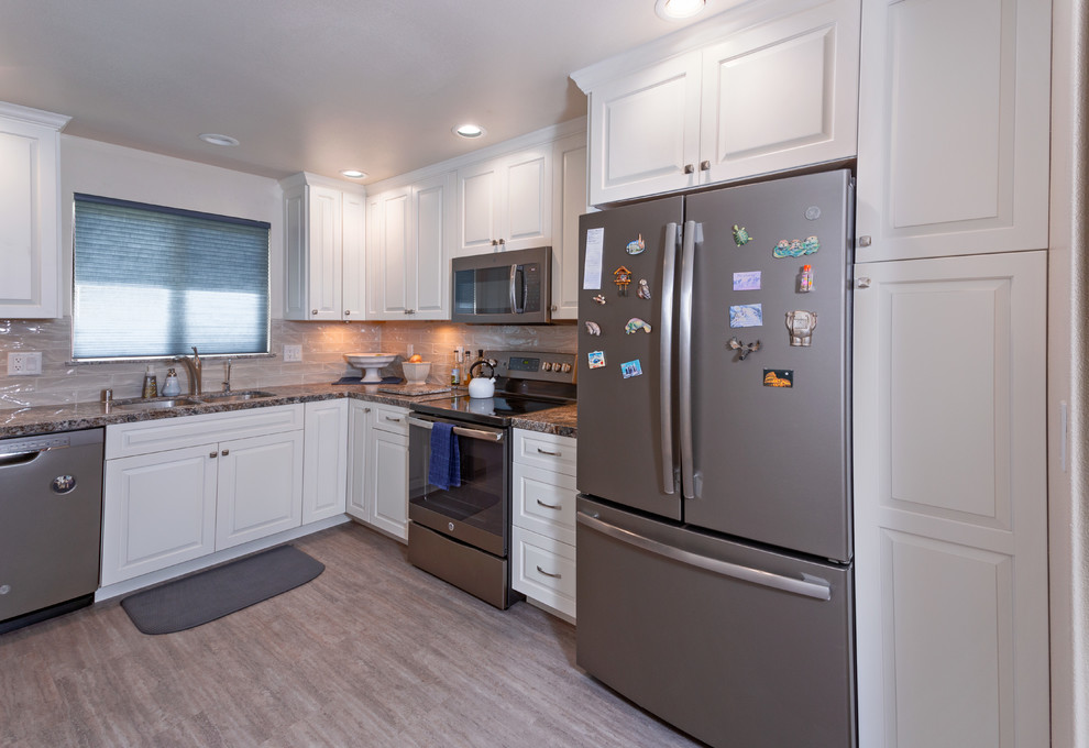 Example of a mid-sized transitional l-shaped vinyl floor and beige floor eat-in kitchen design in Sacramento with a double-bowl sink, raised-panel cabinets, white cabinets, granite countertops, beige backsplash, ceramic backsplash, stainless steel appliances, a peninsula and brown countertops