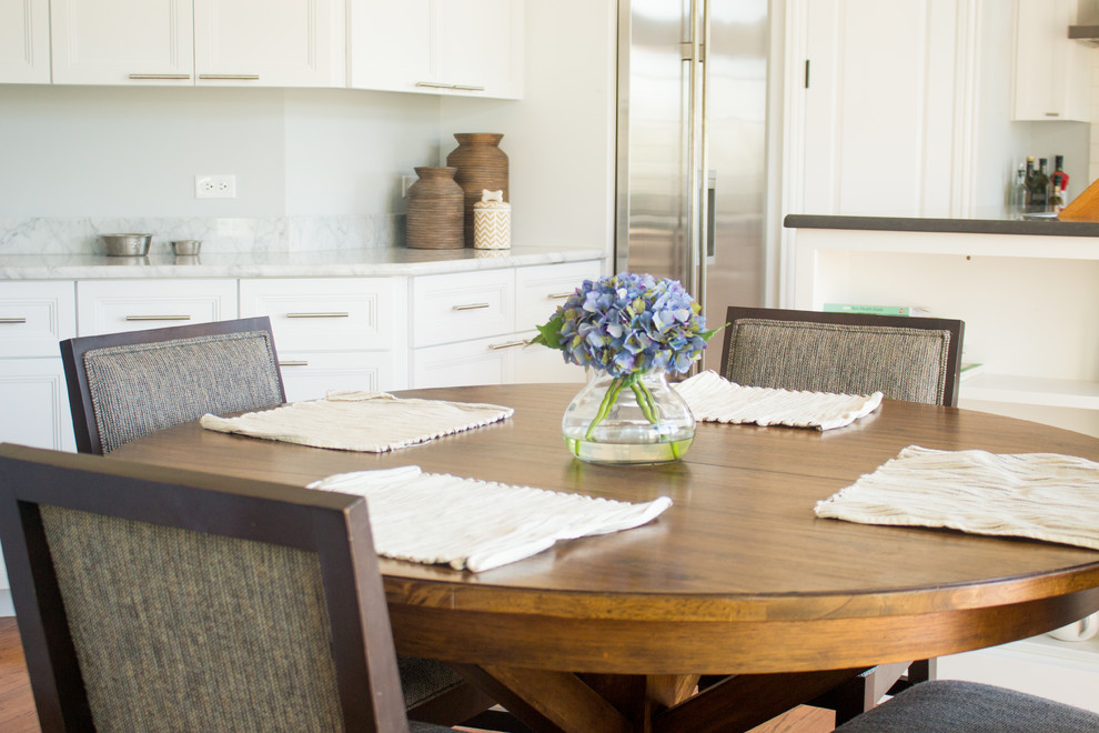 White Kitchen with Gray Marble Counters and Brown Kitchen Table