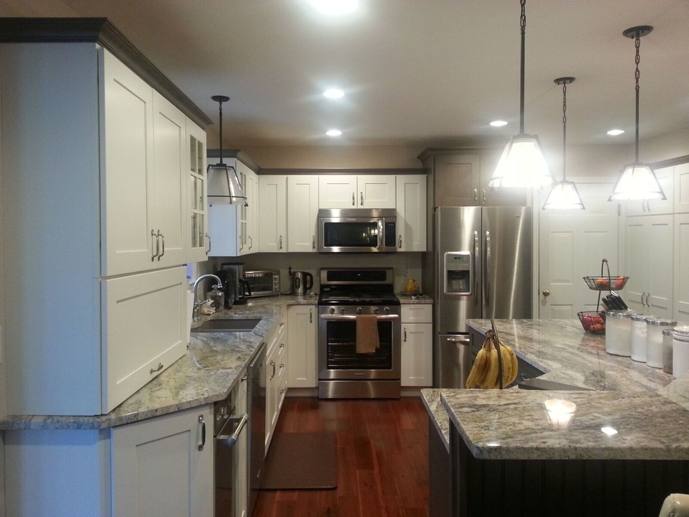 White Kitchen with Grey Island and Refrigerator Traditional