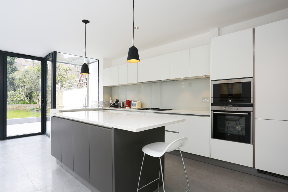 Inspiration for a contemporary eat-in kitchen remodel in London with an island