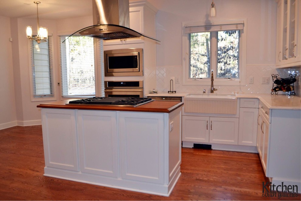White Kitchen With Wood Island and Glass Door Refrigerator Kitchen