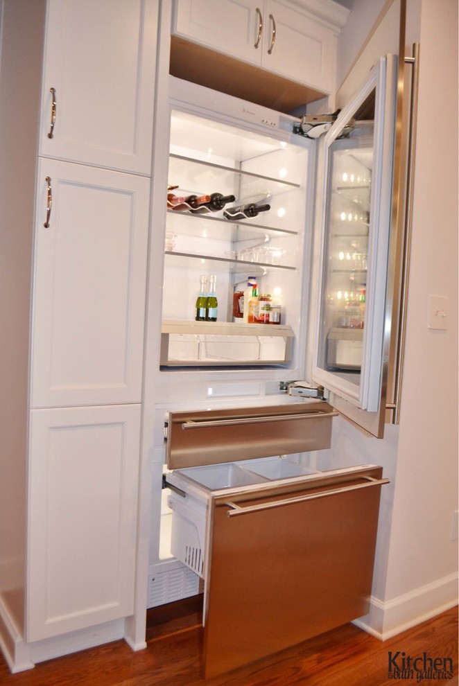 White Kitchen With Wood Island and Glass Door Refrigerator Kitchen