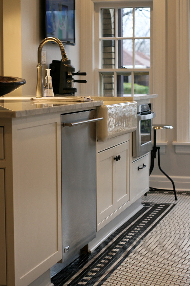 Inspiration for a mid-sized cottage galley ceramic tile eat-in kitchen remodel in Oklahoma City with a farmhouse sink, flat-panel cabinets, white cabinets, marble countertops, white backsplash, subway tile backsplash, stainless steel appliances, an island and gray countertops