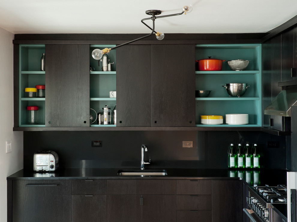 Photo of a contemporary kitchen in New York with flat-panel cabinets and black cabinets.