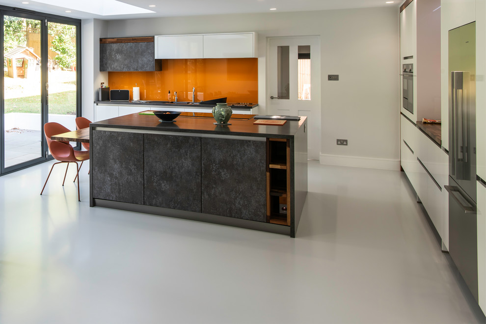 Photo of a large contemporary single-wall kitchen/diner in Sussex with an island and white floors.