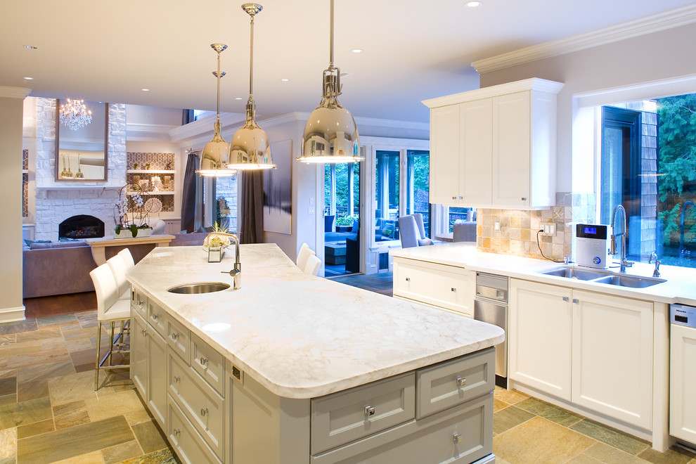 Example of a large transitional l-shaped slate floor open concept kitchen design in Vancouver with an undermount sink, shaker cabinets, white cabinets, marble countertops, gray backsplash, stone tile backsplash, paneled appliances and an island