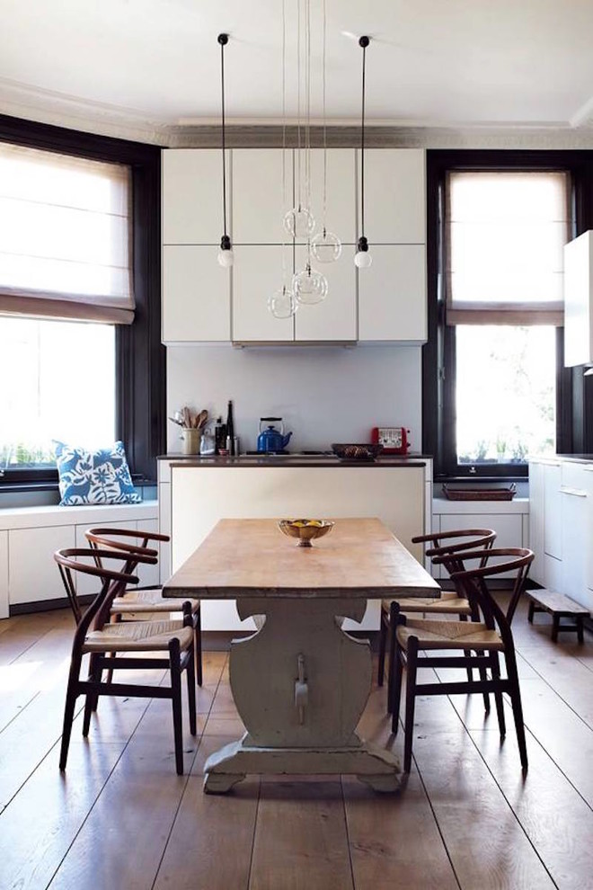 Eat-in kitchen - mid-sized contemporary l-shaped light wood floor and brown floor eat-in kitchen idea in Sydney with flat-panel cabinets, white cabinets, no island, a drop-in sink, quartz countertops, white backsplash, ceramic backsplash, stainless steel appliances and white countertops