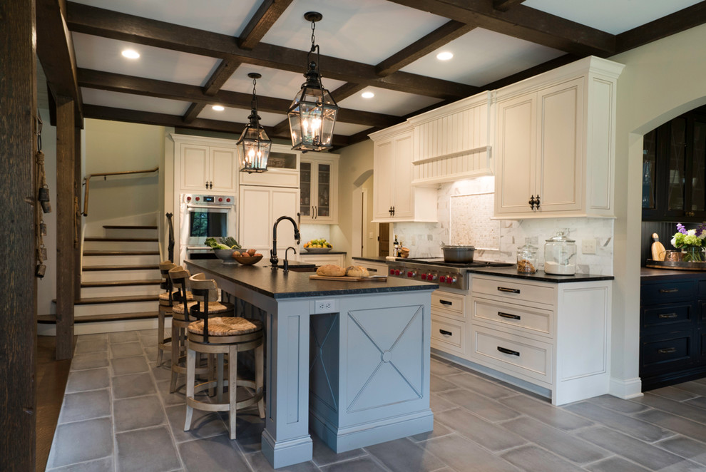 This is an example of a medium sized rustic l-shaped open plan kitchen in St Louis with a belfast sink, flat-panel cabinets, white cabinets, soapstone worktops, white splashback, marble splashback, integrated appliances, porcelain flooring, an island and grey floors.
