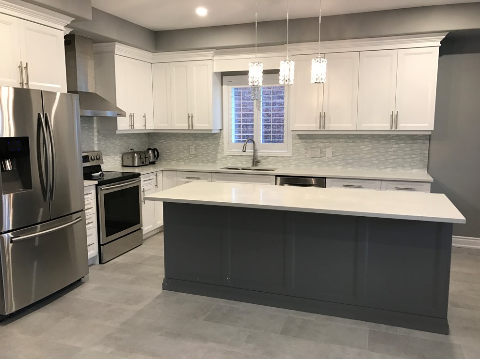 Photo of a medium sized modern l-shaped enclosed kitchen in Toronto with a double-bowl sink, shaker cabinets, white cabinets, stainless steel appliances, an island and grey floors.