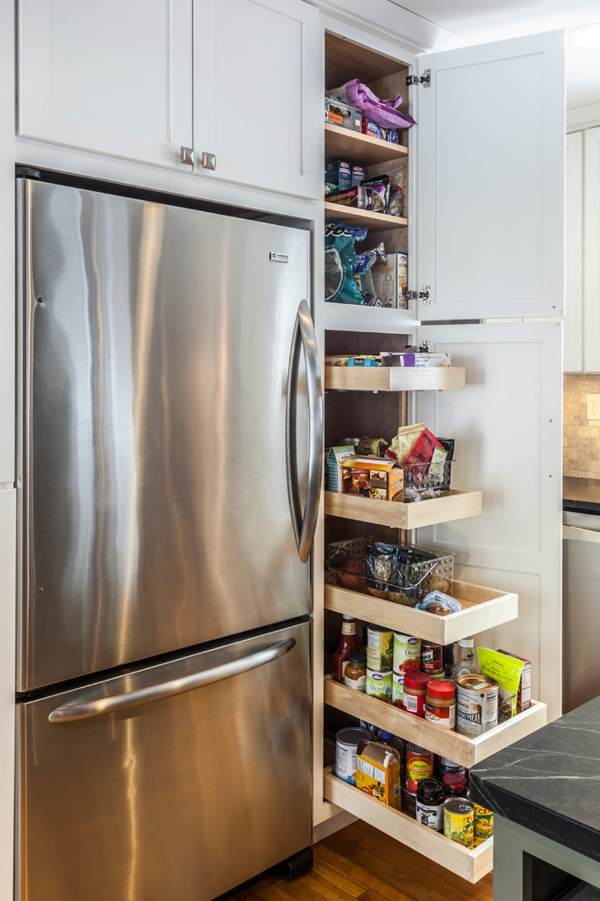 Medium sized traditional kitchen pantry in Burlington with a submerged sink, shaker cabinets, white cabinets, soapstone worktops, stainless steel appliances, light hardwood flooring and an island.