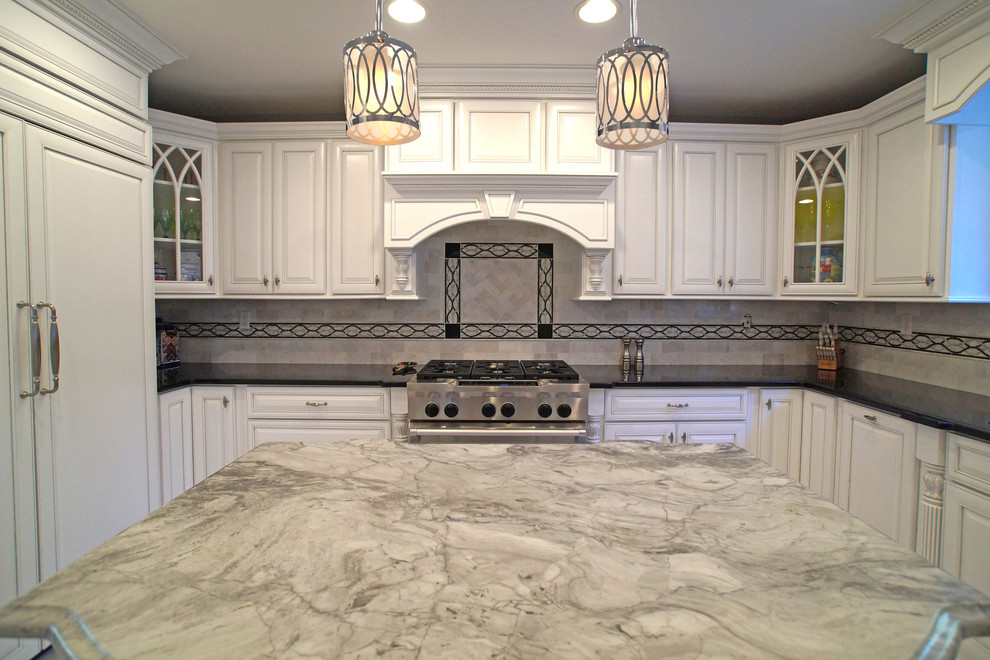 Example of a small classic u-shaped marble floor kitchen pantry design in St Louis with an undermount sink, raised-panel cabinets, white cabinets, granite countertops, stainless steel appliances and an island