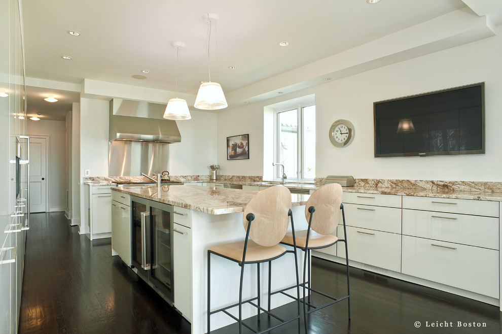 Large modern u-shaped kitchen/diner in Boston with a submerged sink, flat-panel cabinets, white cabinets, granite worktops, stainless steel appliances, dark hardwood flooring and an island.